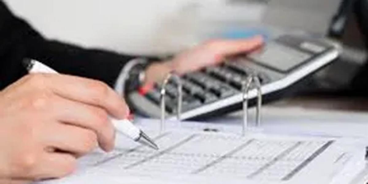 Do You Know What You Plan on Paying Yourself in Retirement Graphic calculator hand holding a pen looking at a balance sheet